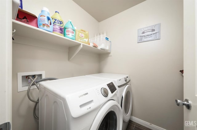 washroom featuring laundry area, washing machine and dryer, and baseboards