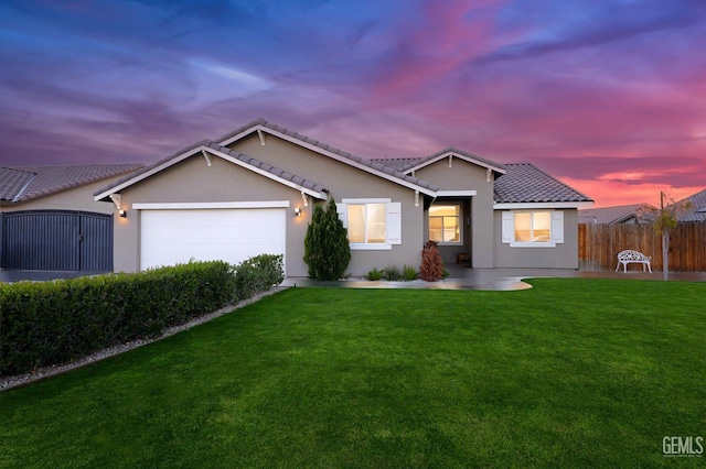 ranch-style house with a tile roof, stucco siding, an attached garage, fence, and a front lawn