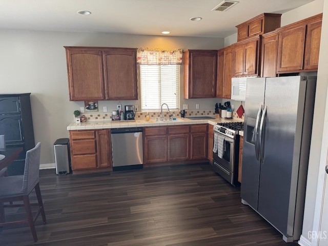11908 Nebula Ct, Bakersfield, CA 93312 - kitchen with appliances with stainless steel finishes, tile countertops, dark wood-type flooring, a sink, and recessed lighting