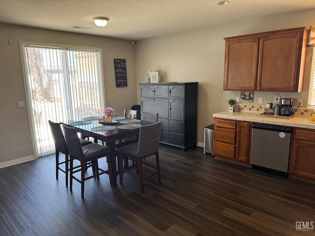 11908 Nebula Ct, Bakersfield, CA 93312 - dining area featuring dark wood-style floors and baseboards