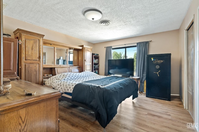 1125 Rose Ave, Shafter, CA 93263 - bedroom featuring light wood-style floors and a textured ceiling