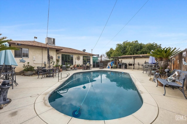 view of swimming pool with a patio and central AC