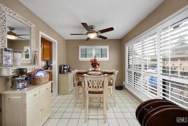 tiled dining area with ceiling fan