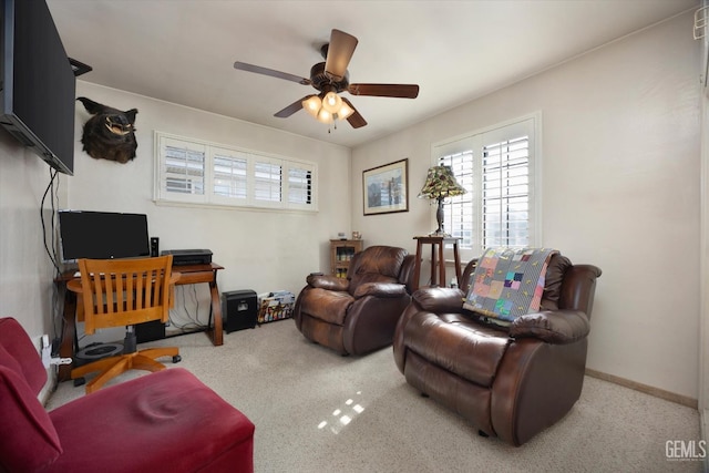 carpeted office space with ceiling fan