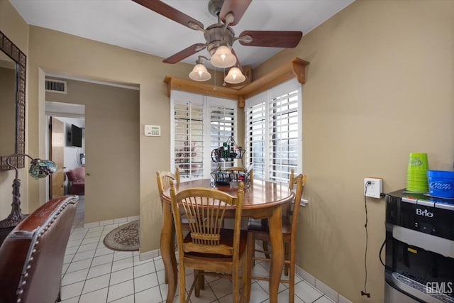 dining space with ceiling fan and light tile patterned floors