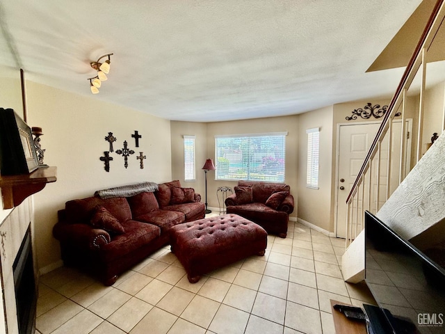 4600 Beechwood St Unit 135, Bakersfield, CA 93309 - living room featuring light tile patterned floors, baseboards, stairs, and a fireplace