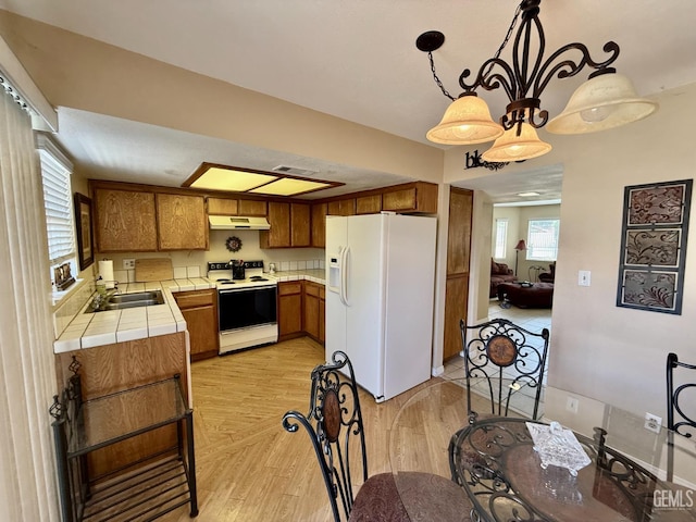 4600 Beechwood St Unit 135, Bakersfield, CA 93309 - kitchen featuring white appliances, tile countertops, brown cabinets, and a sink