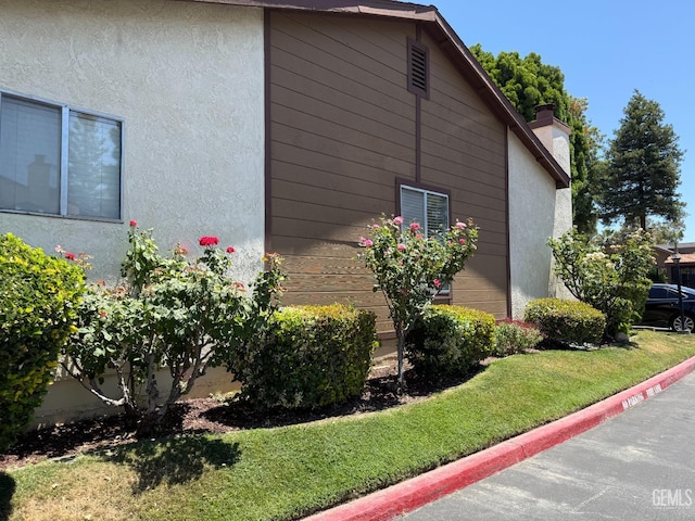 4600 Beechwood St Unit 135, Bakersfield, CA 93309 - view of property exterior with stucco siding and a chimney