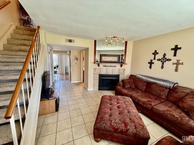4600 Beechwood St Unit 135, Bakersfield, CA 93309 - living area with light tile patterned floors, stairs, and a tiled fireplace