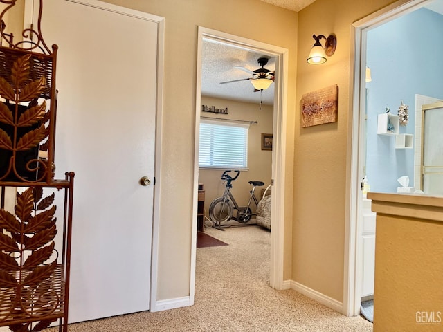 4600 Beechwood St Unit 135, Bakersfield, CA 93309 - corridor featuring light carpet, baseboards, and a textured ceiling