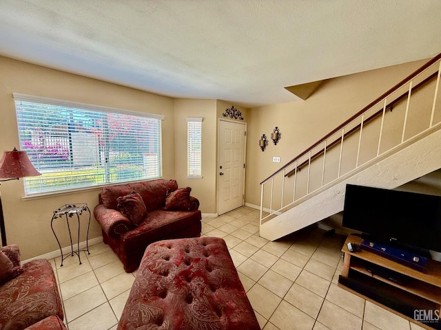 4600 Beechwood St Unit 135, Bakersfield, CA 93309 - living area featuring stairway, light tile patterned flooring, and baseboards