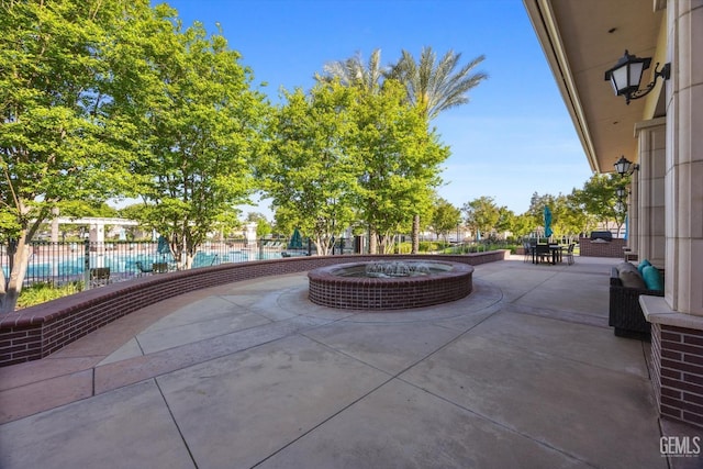 view of patio featuring fence and a community pool