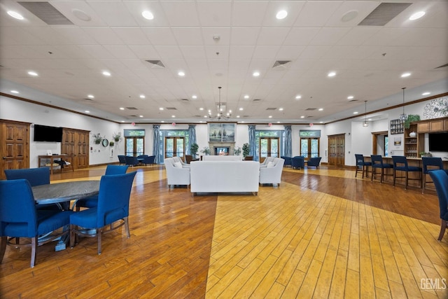 interior space featuring light wood-style floors, recessed lighting, and visible vents