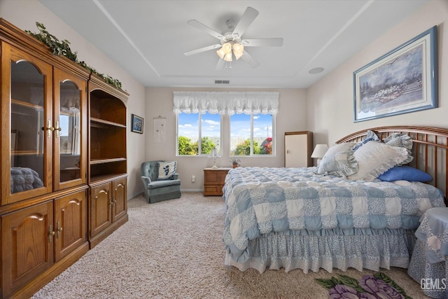 bedroom featuring visible vents, a ceiling fan, and carpet flooring