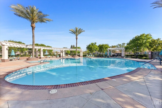 pool with a pergola and a patio area