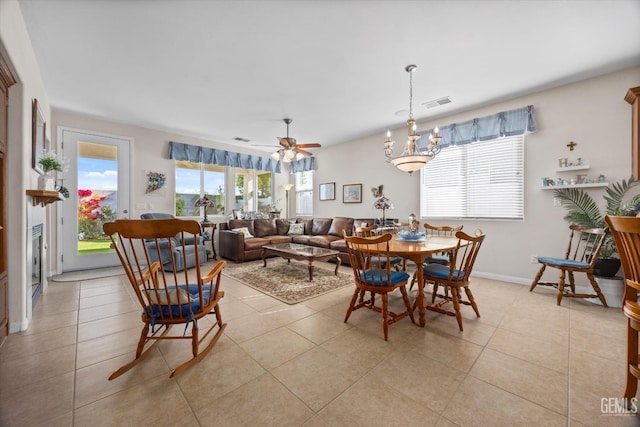 dining room featuring baseboards, visible vents, light tile patterned floors, and a ceiling fan