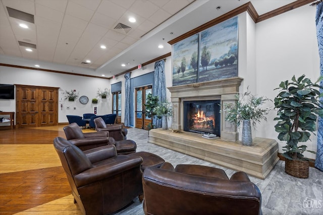 living room featuring recessed lighting, crown molding, visible vents, a high end fireplace, and wood finished floors
