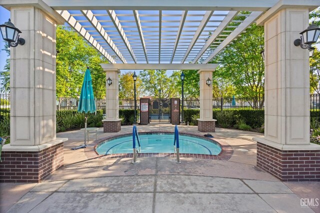 view of swimming pool featuring a gate, fence, and a pergola