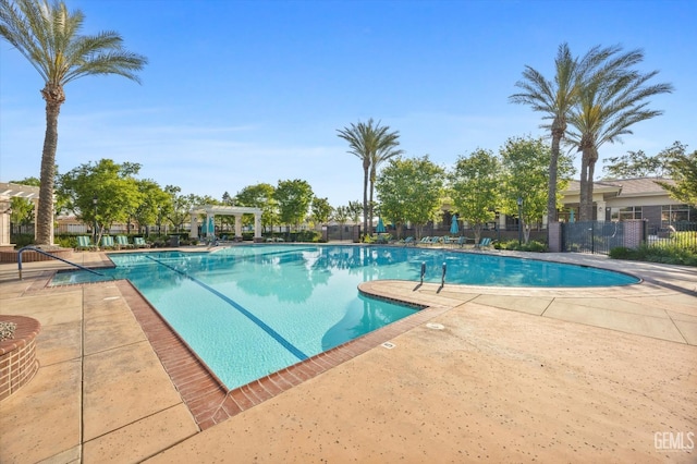 community pool with fence, a patio area, and a pergola