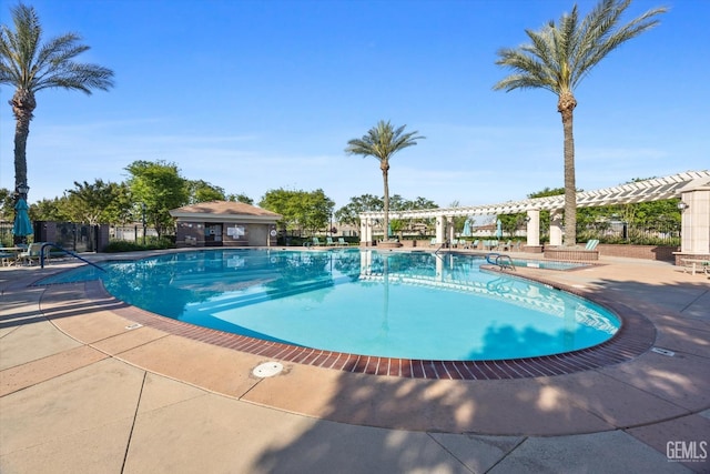 community pool with fence, a patio area, and a pergola
