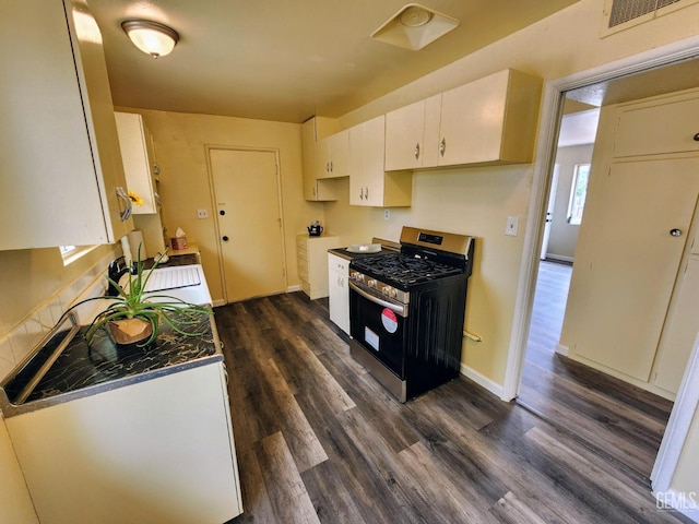 4856 Morales St, New Cuyama, CA 93254 - kitchen with stainless steel gas stove, dark wood-type flooring, a sink, white cabinets, and baseboards