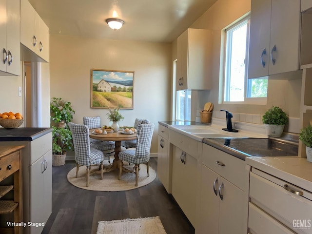 4856 Morales St, New Cuyama, CA 93254 - kitchen with dark wood finished floors, white cabinets, a sink, black electric cooktop, and light countertops