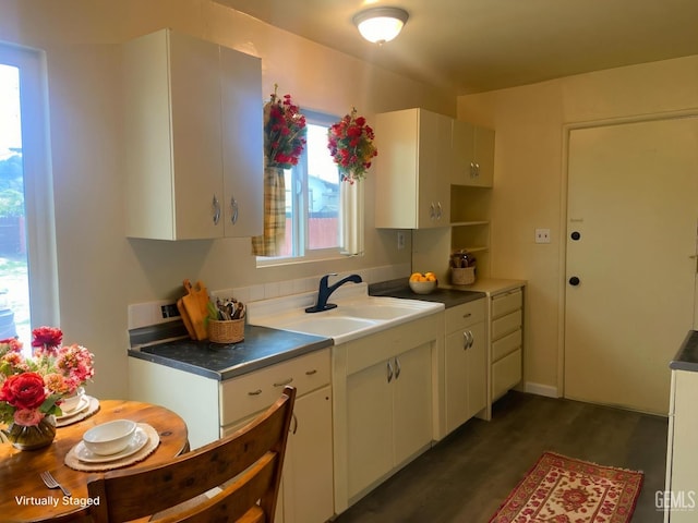 4856 Morales St, New Cuyama, CA 93254 - kitchen featuring dark wood-style flooring, a sink, and white cabinetry
