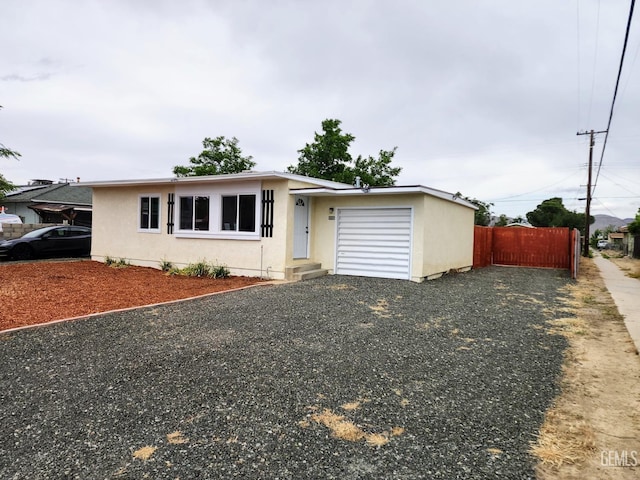 4856 Morales St, New Cuyama, CA 93254 - ranch-style house with an attached garage, driveway, and stucco siding