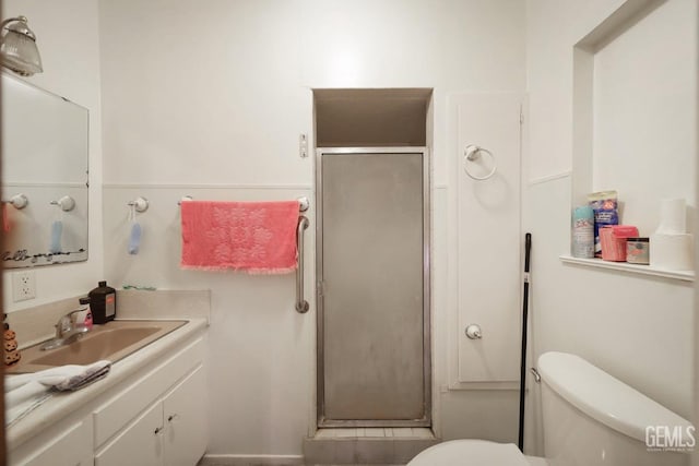 bathroom featuring vanity, toilet, and walk in shower