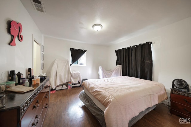 bedroom with dark hardwood / wood-style flooring