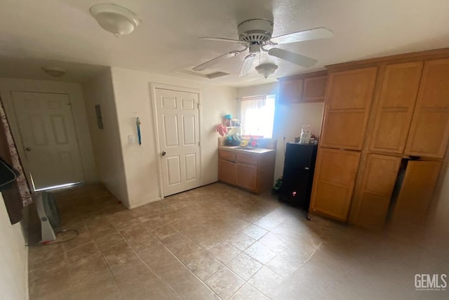 unfurnished bedroom featuring ceiling fan and sink