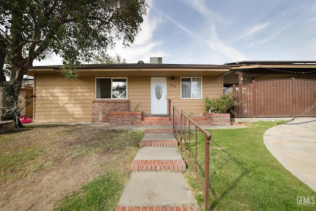 ranch-style home with a front lawn