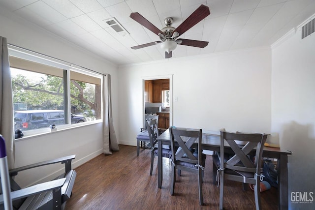 dining room with ceiling fan, dark hardwood / wood-style flooring, and crown molding