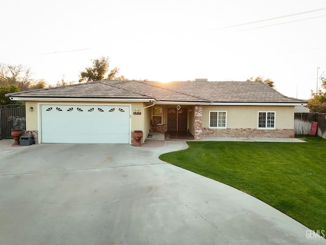 single story home with a garage and a front yard