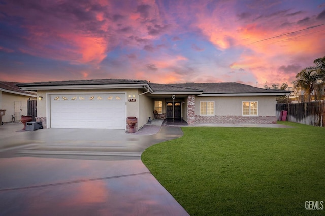 view of front of home featuring a garage and a yard