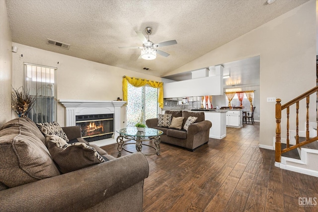 1914 Hummingbird Ave, Delano, CA 93215 - living area featuring lofted ceiling, a textured ceiling, stairway, ceiling fan, and dark wood-style floors
