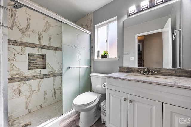 1914 Hummingbird Ave, Delano, CA 93215 - bathroom with a stall shower, toilet, vanity, and wood finished floors
