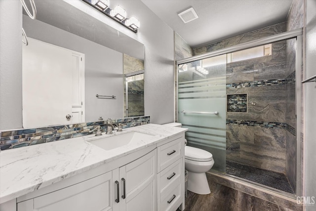 1914 Hummingbird Ave, Delano, CA 93215 - full bath featuring a shower stall, wood finished floors, toilet, and vanity