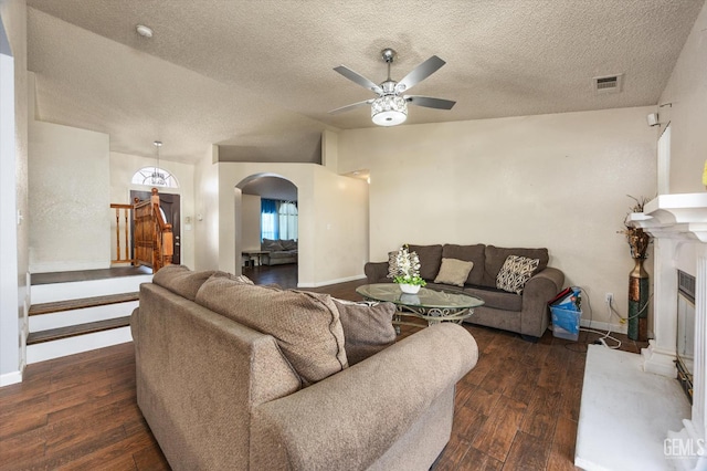 1914 Hummingbird Ave, Delano, CA 93215 - living room with arched walkways, a ceiling fan, hardwood / wood-style floors, baseboards, and a textured ceiling