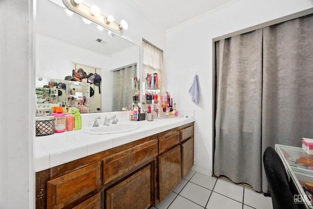 bathroom featuring crown molding, vanity, and tile patterned flooring