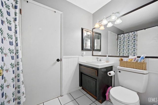 bathroom featuring vanity, tile patterned floors, toilet, and walk in shower