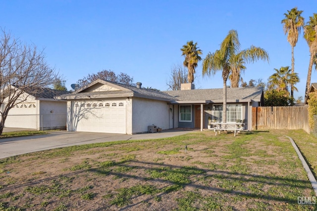 ranch-style home featuring a garage and a front lawn