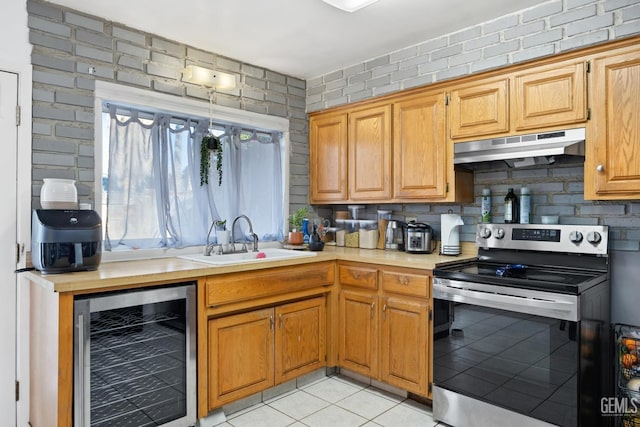 kitchen with wine cooler, sink, tasteful backsplash, light tile patterned floors, and stainless steel electric stove