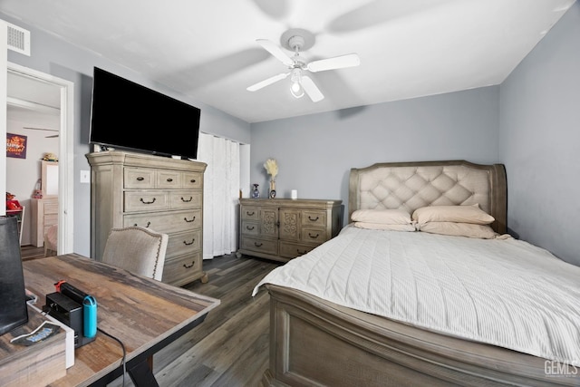 bedroom with ceiling fan and dark hardwood / wood-style floors