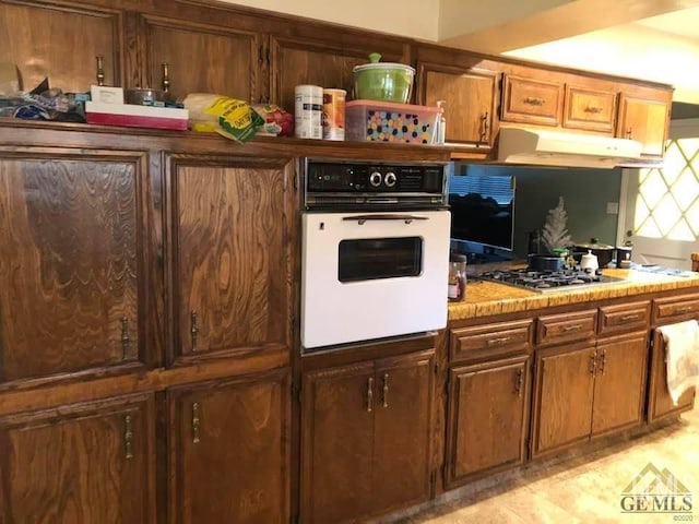 kitchen featuring oven and stainless steel gas cooktop