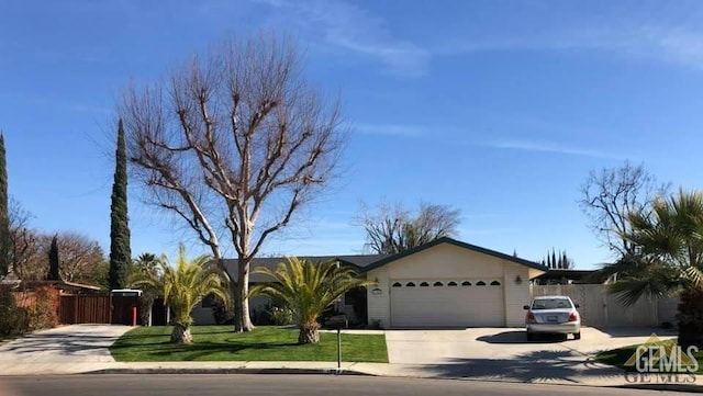 ranch-style home with a garage and a front lawn