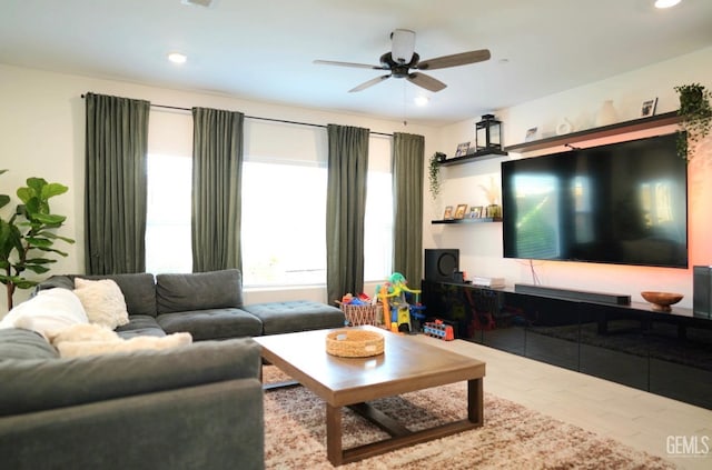 living room featuring hardwood / wood-style floors and ceiling fan