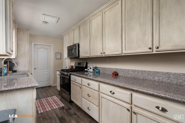 kitchen with dark hardwood / wood-style floors, sink, and stainless steel appliances