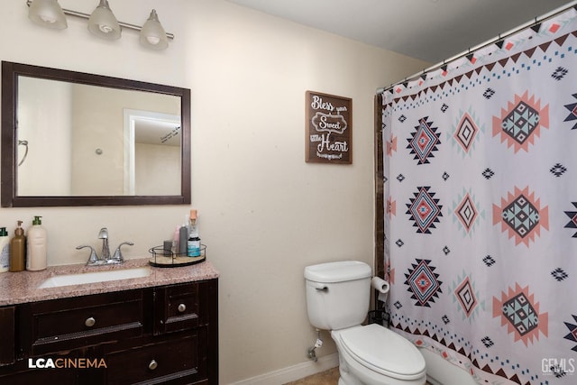 bathroom with vanity, a shower with shower curtain, and toilet