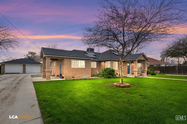 view of front of home featuring a lawn, an outdoor structure, and a garage